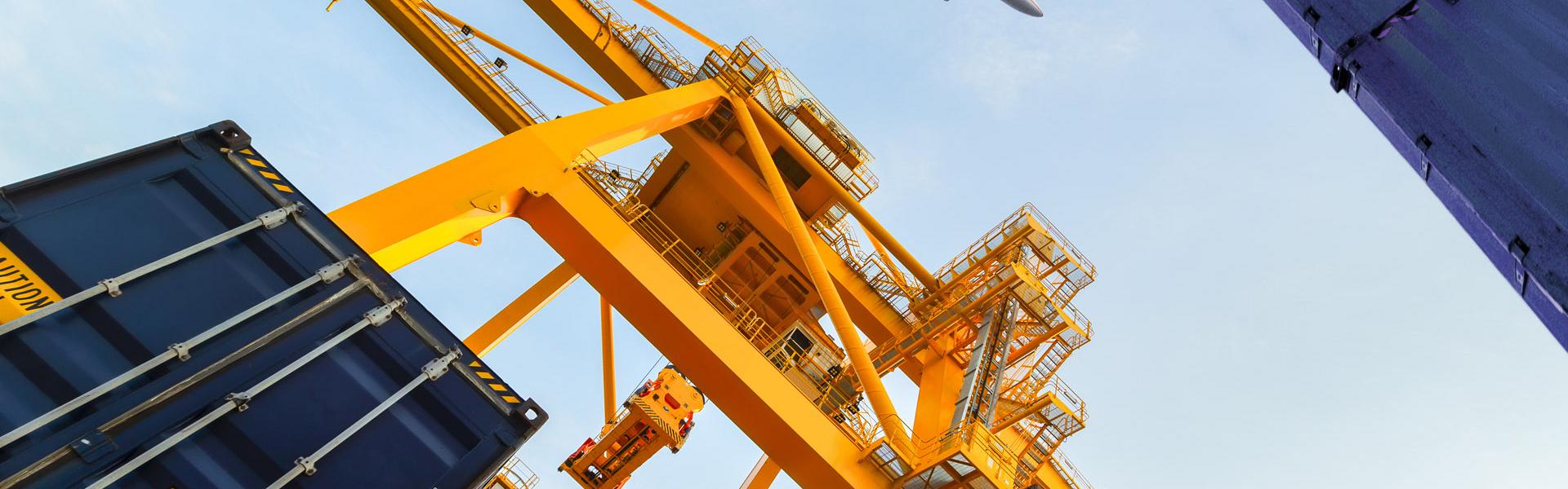 container cargo freight ship with working crane loading bridge shipyard logistic