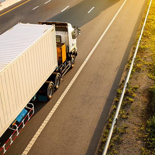 white truck highway road with container transportation concept import export logistic industrial transporting land transport expressway motion blurred soft focus