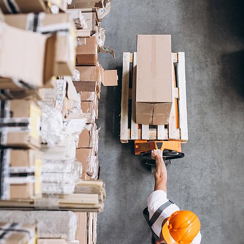 young man working warehouse with boxes