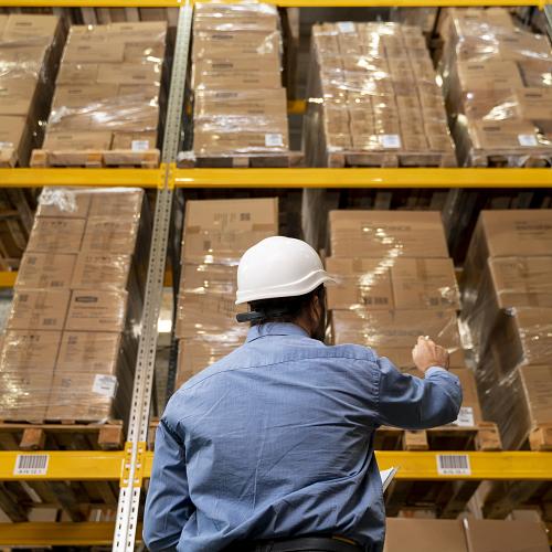 man with helmet working warehouse