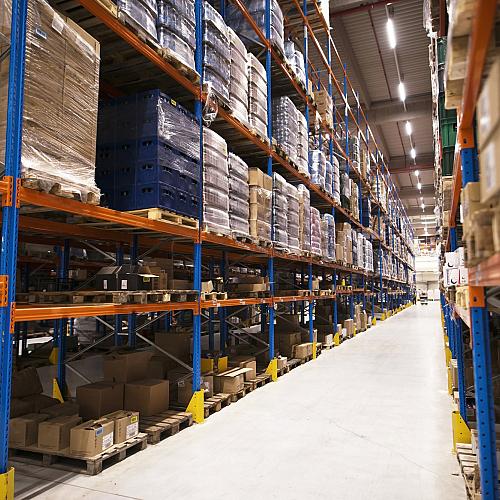 interior large distribution warehouse with shelves stacked with palettes goods ready market